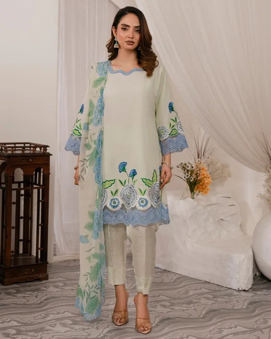 Woman wearing elegant light green Pakistani embroidered formal suit with blue floral accents and matching dupatta