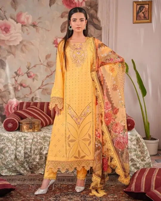 Woman wearing elegant yellow embroidered lawn suit with floral printed dupatta, traditional Pakistani outfit