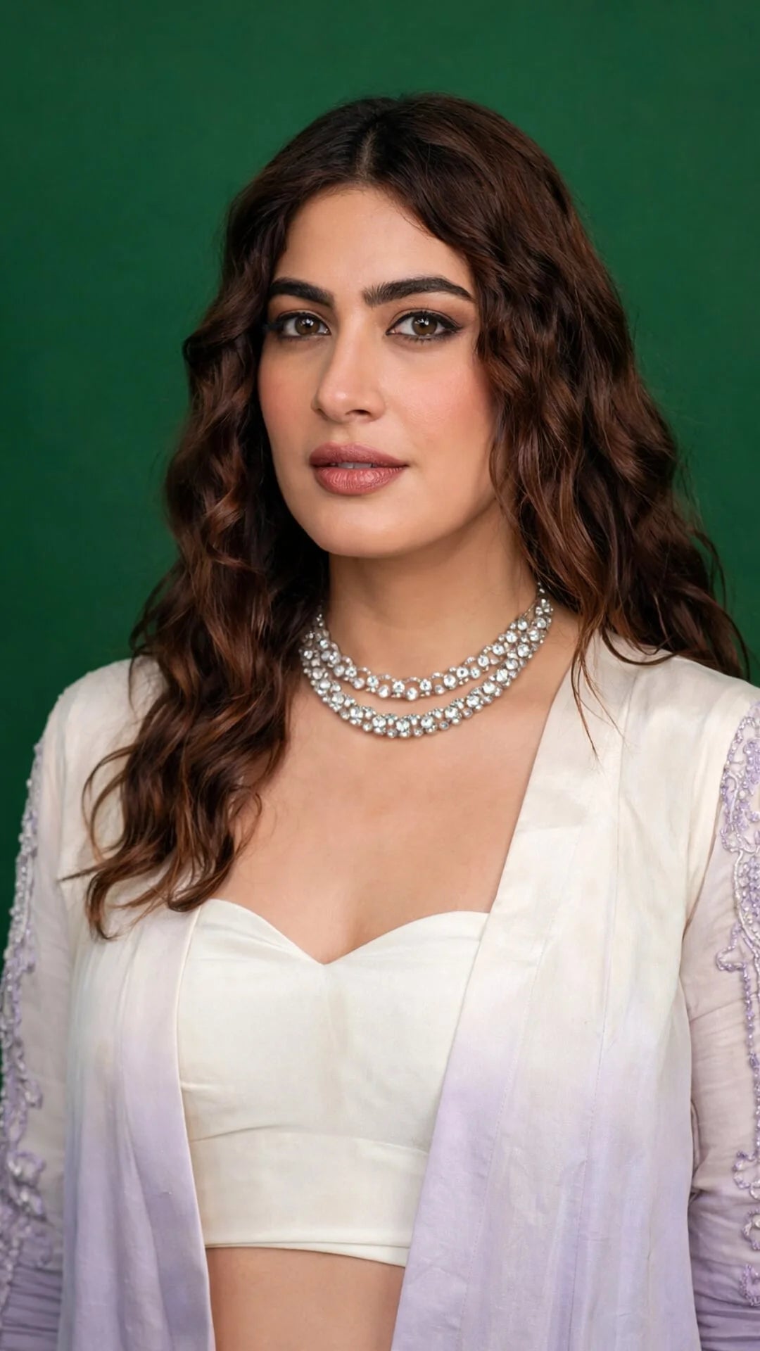 Woman wearing a white blouse with a green background