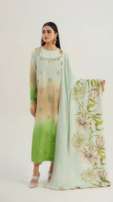 Woman wearing a green and beige embroidered outfit with a matching dupatta on a white background
