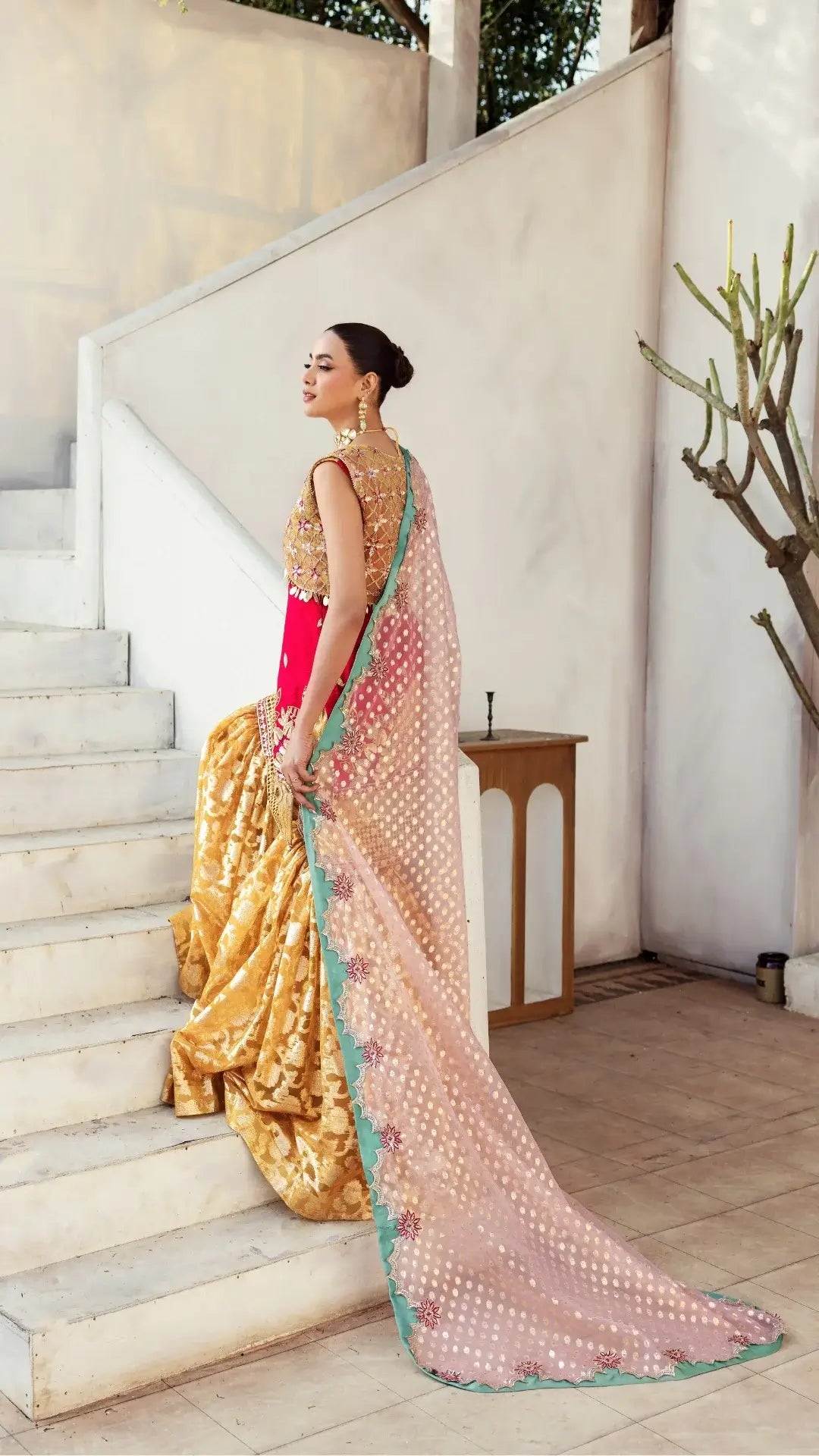 Woman in a traditional outfit standing on a staircase