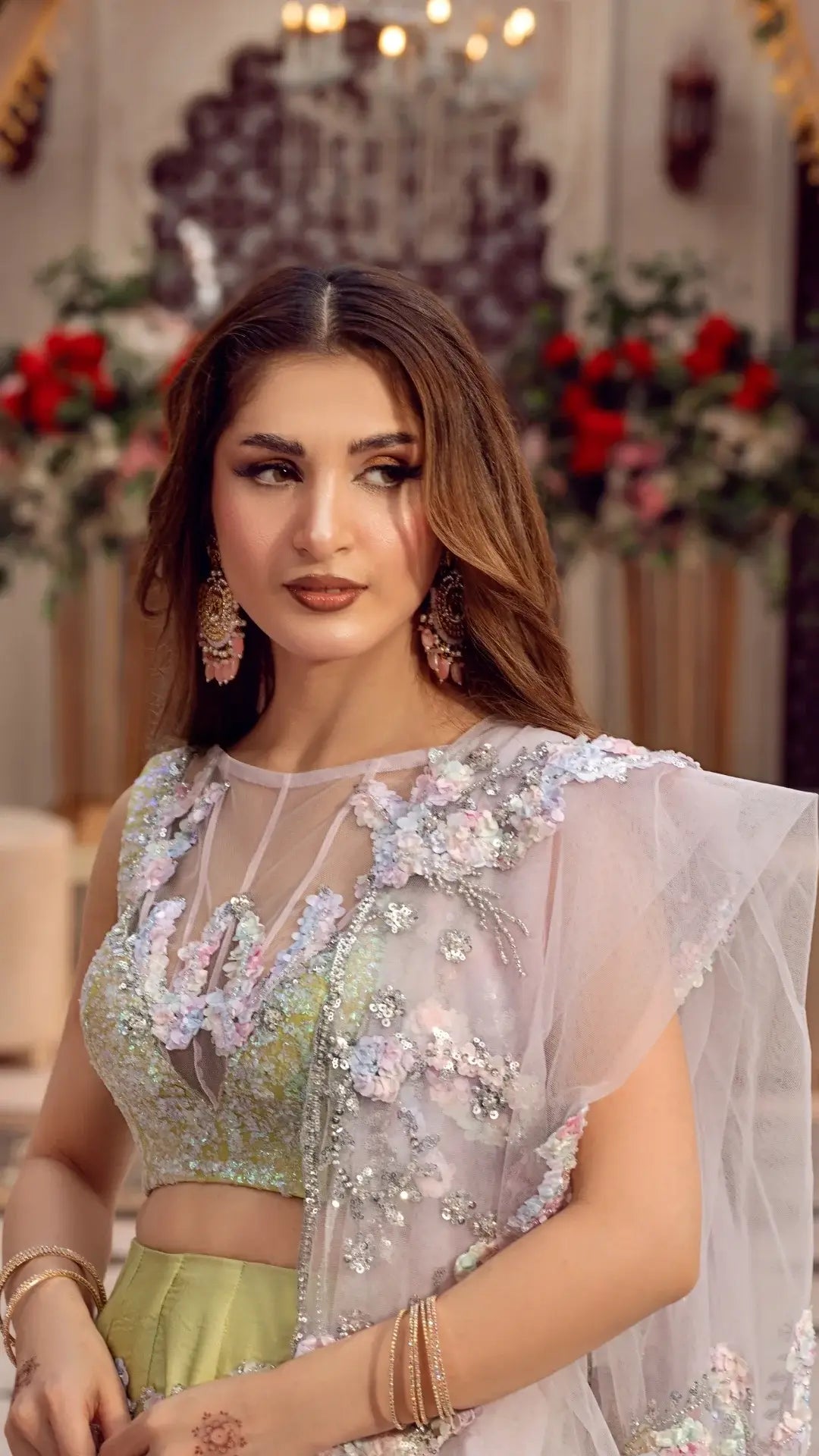 Woman in luxury Pakistani formal dress with floral embroidery and sheer dupatta, elegant party wear
