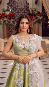Woman in luxury pastel green floral embellished lehenga dress, formal Pakistani fashion