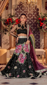 Woman in luxury Pakistani formal dress with black floral lehenga and embroidered dupatta