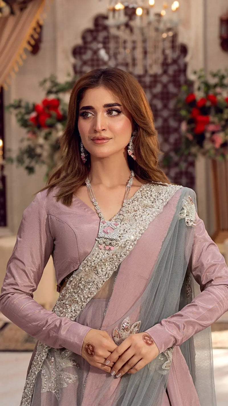 Woman wearing a mauve embellished formal dress with sheer dupatta and floral details