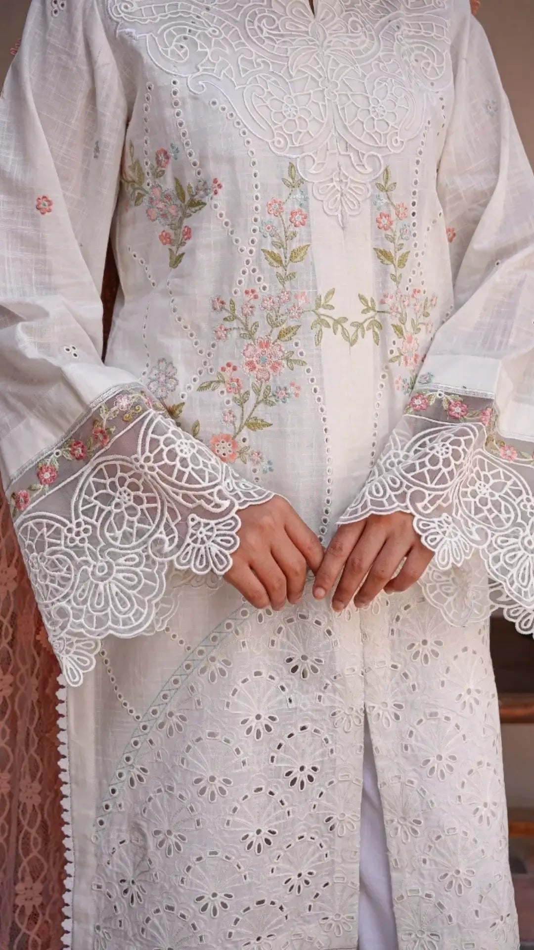 White embroidered garment with intricate patterns on a blurred background
