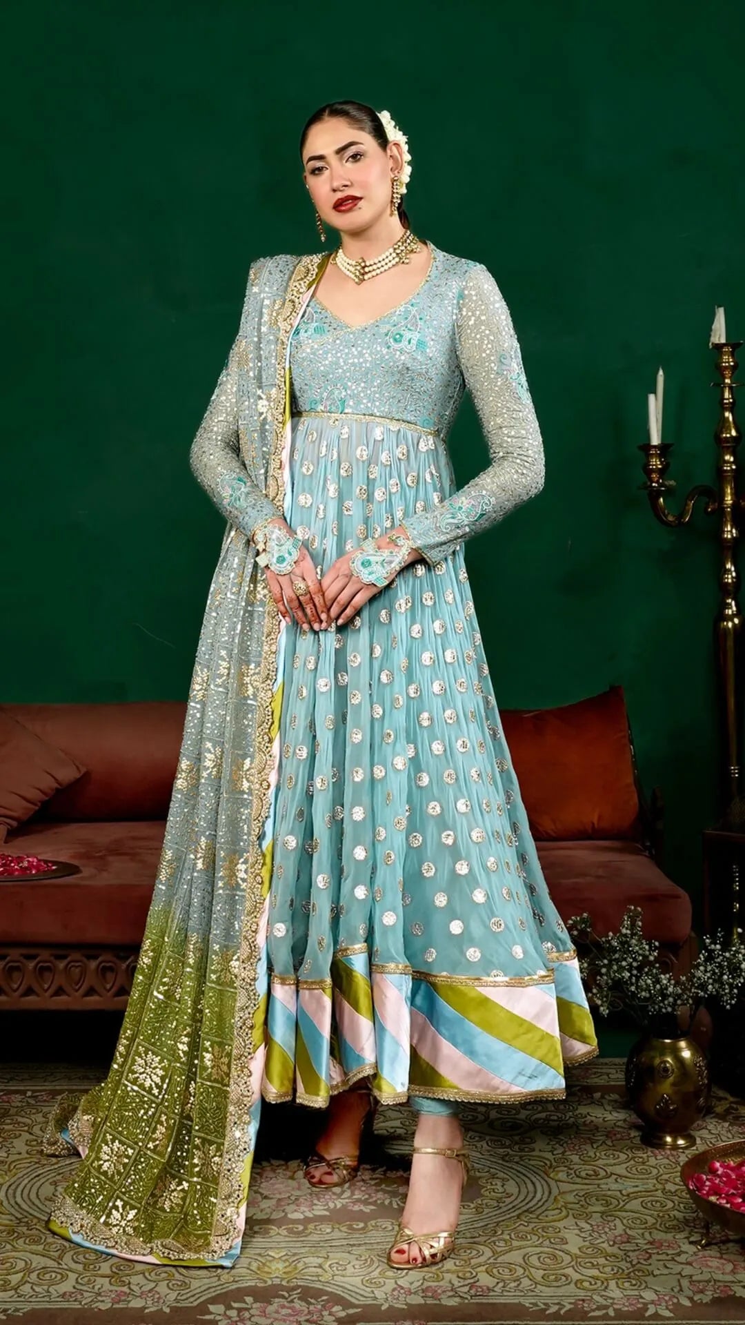 Woman in a traditional outfit with a green background