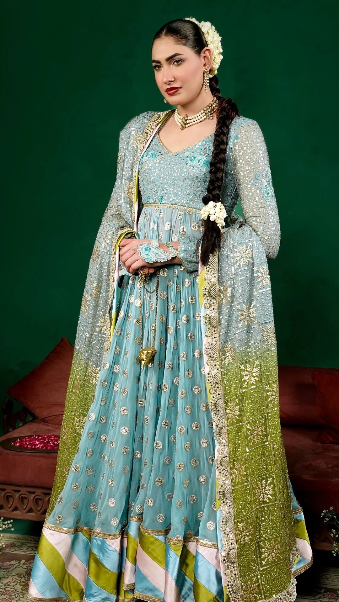 Woman in a traditional outfit with a green background